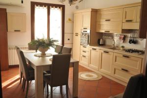 a kitchen with a table and chairs and a kitchen with a window at Le Pigne Siciliane in Terrasini