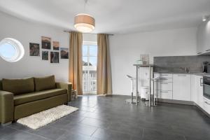 a living room with a couch and a kitchen at Stadtkernnahes Wohnen in Düren in Düren - Eifel
