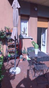a patio with an umbrella and a table and chairs at M. BINI B&B in Bologna