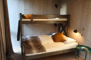 a bedroom with two bunk beds in a room at New and fresh apartement in Kvitfjell in Favang