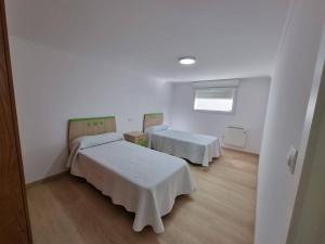 Łóżko lub łóżka w pokoju w obiekcie Terrazas del Cantábrico
