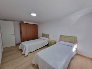 Łóżko lub łóżka w pokoju w obiekcie Terrazas del Cantábrico