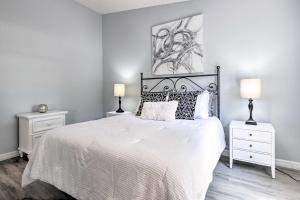 a bedroom with a white bed with two night stands at Inviting Lady Lake House In the Village! in Lady Lake