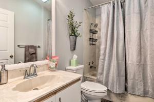 a bathroom with a sink and a toilet and a shower at Inviting Lady Lake House In the Village! in Lady Lake +25 photos