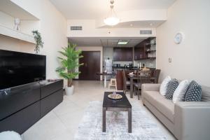 a living room with a couch and a table at HiGuests - Deiras Lucky Find, 5-min to the Airport in Dubai