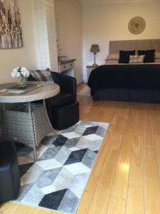 a living room with a bed and a table at Forest B & B in Ringwood