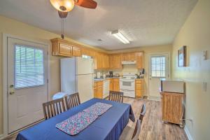 eine Küche mit einem Tisch und einem weißen Kühlschrank in der Unterkunft Cartersville Family Home with Spacious Backyard in Cartersville