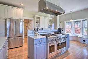 a kitchen with a stove and a refrigerator at Charming Retreat with Fire Pit and Spacious Yard! 