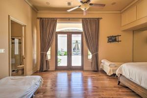 a bedroom with two beds and a ceiling fan at Stunning Palmdale Villa Oasis on Vineyard! in Palmdale +35 photos