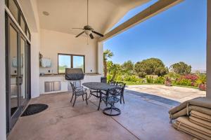 a living room with a table and chairs and a patio at Stunning Palmdale Villa Oasis on Vineyard! in Palmdale