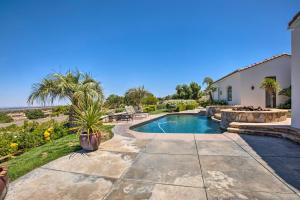 a backyard with a swimming pool and a house at Stunning Palmdale Villa Oasis on Vineyard! in Palmdale