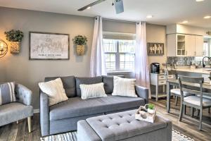 a living room with a couch and a kitchen at Branson Retreat with Balcony and 18-Hole Golf Course! in Branson