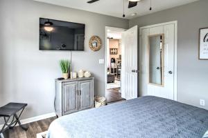 a bedroom with a bed and a television on the wall at Branson Retreat with Balcony and 18-Hole Golf Course! in Branson +30 photos