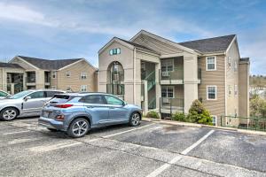 two cars parked in a parking lot in front of a house at Branson Retreat with Balcony and 18-Hole Golf Course! in Branson