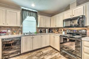 uma cozinha com armários e electrodomésticos brancos e uma janela em Cozy Hardin Retreat with Lake Kentucky View! em Aurora