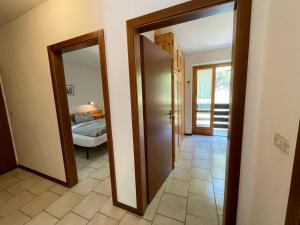 a hallway with two doors leading to a bedroom at Appartamenti Vacanze Lagolo in Lagolo di Calavino +96 photos