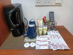 a table with a coffee maker and drinks on it at VILLA WANIE INN in Setiu