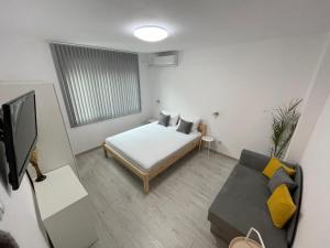 a small room with a bed and a couch at @Home+ in Veliko Tŭrnovo
