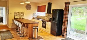 a kitchen with a counter top and a refrigerator at Fairview Cottage Watford in Leavesden Green