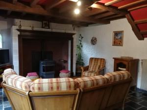 a living room with a couch and a fireplace at GITE DU MOULIN in Renty