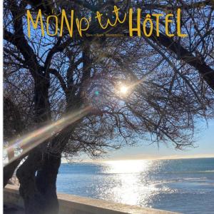 a magazine cover with a tree next to the water at Mon P'tit Hôtel in Le Grau-dʼAgde