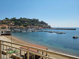 a view of a beach with boats in the water at Hotel Plaza in Porto Azzurro