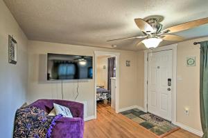 a living room with a ceiling fan and a purple couch at Lovely Tacoma Cottage with Fire Pit, Near Dtwn! in Tacoma