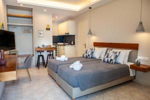 a bedroom with a large bed and a kitchen at Spyridoula Resort Hotel in Corfu in Gouvia