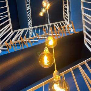 a couple of lights hanging from a ceiling at Mon P'tit Hôtel in Le Grau-dʼAgde
