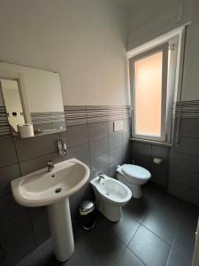 a bathroom with a sink and a toilet at Il Guasco Rooms in Ancona