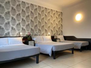Postel nebo postele na pokoji v ubytování Hotel RossoVino Milano