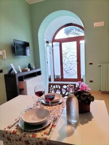 a table with two glasses of wine on a table at Casa Lamberti B&B in Cava deʼ Tirreni