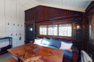 uma sala de estar com uma mesa de madeira e um sofá em Sprucewold Coastal Retreat em Boothbay Harbor
