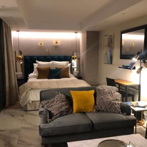 a bedroom with a large bed and a couch at Marqués Petit Premium in Denia