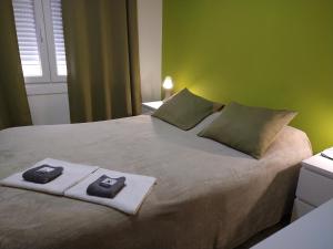 a bed with two pillows on top of it at PENSION132 in A Coruña
