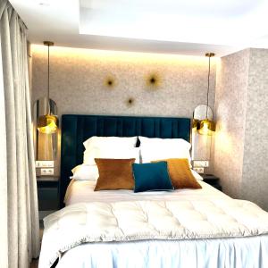 a bedroom with a large white bed with two pillows at Marqués Petit Premium in Denia