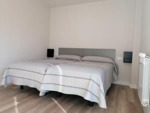 a bedroom with a large bed with two pillows at Casa Patxikuzuria in Espinal-Auzperri