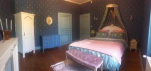 1 dormitorio con 1 cama con dosel en Le manoir de la Source, en Cronat