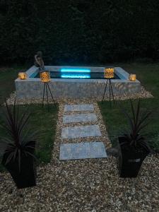a stone bench with a blue light on it at Overdale Motel in Lisburn