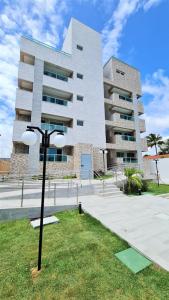 a building with a street light in front of it at Makambira Residence 201 in Porto De Galinhas