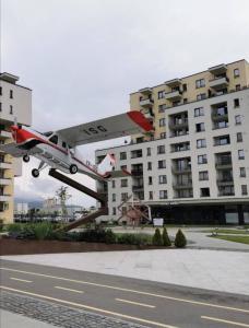 a small plane is flying over a building at Luxury panorama apartament,Coresi in Braşov