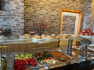 a buffet line with many different types of food at Hotel Kamomil in Durrës