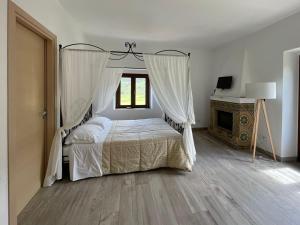 a bedroom with a canopy bed and a fireplace at Antico Borgo Buonanotte in San Mauro Castelverde +48 photos