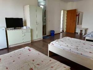 a room with two beds and a flat screen tv at CentrRooms-DS in Struga