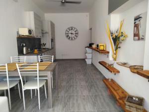 a kitchen and dining room with a table and chairs at Jasmin at Bayview in Pembroke +10 photos