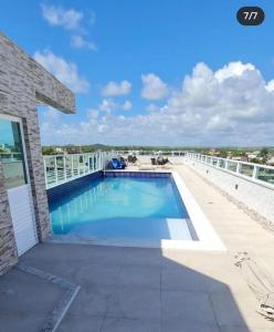 a swimming pool on the roof of a house at Makambira Residence 201 in Porto De Galinhas