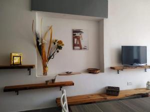 a living room with a tv on a wall at Jasmin at Bayview in Pembroke