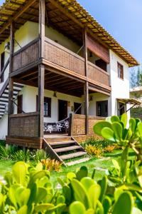 a house with a staircase leading to the front of it at Bahia Soul - Bangalô Lua - Grupo Barril Hospedagens in Marau