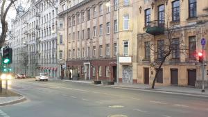 an empty city street with a traffic light and buildings at kauno street home in Vilnius