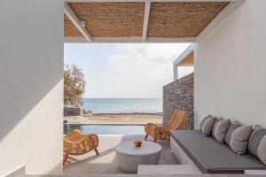 a living room with a couch and a view of the ocean at SummerSalt Villa Paros in Molos Parou